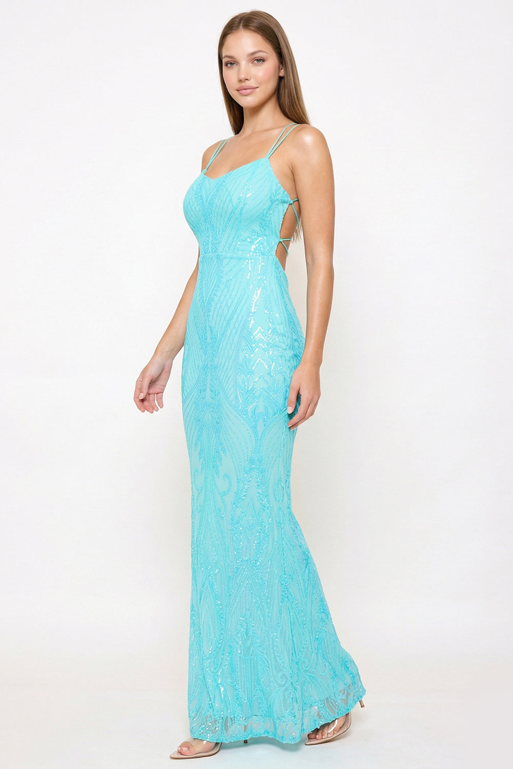 Bright turquoise sequin evening gown with a floor-length silhouette, spaghetti straps, and an open lace-up back.