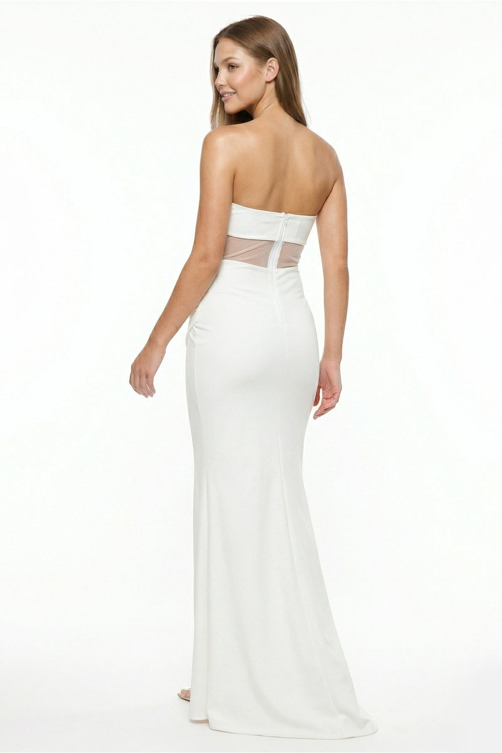 Model wearing a white strapless floor-length mermaid gown with sheer waist detail for an elegant formal occasion.
