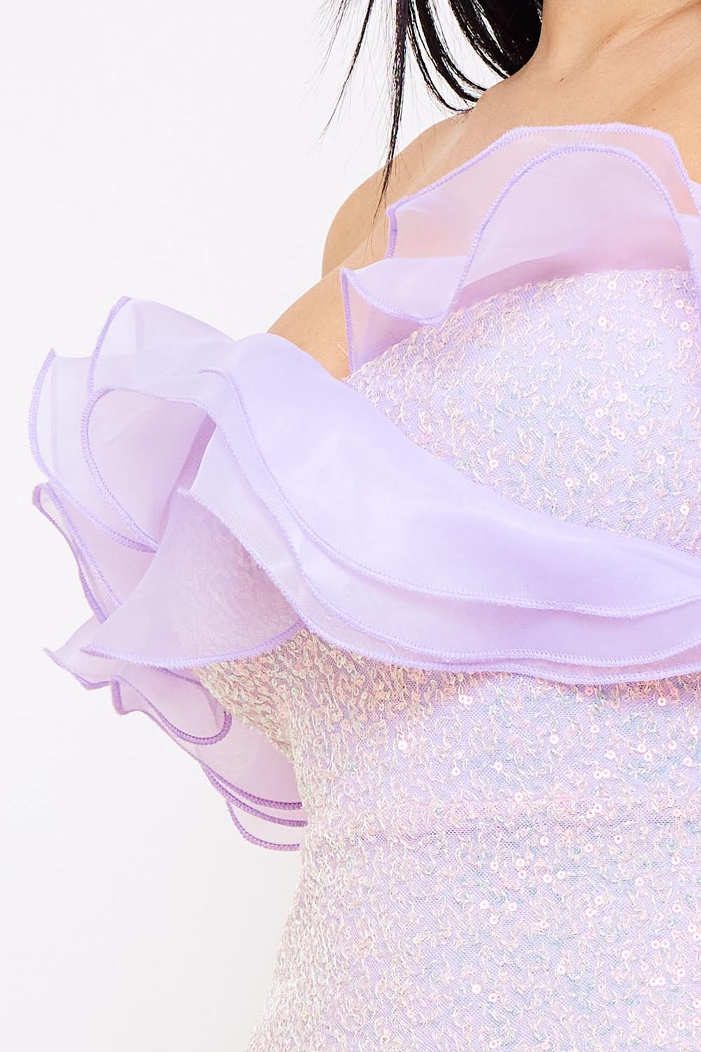 Lavender sequin mini dress with an off-shoulder ruffled neckline, perfect for a glamorous party look from Boutinie.