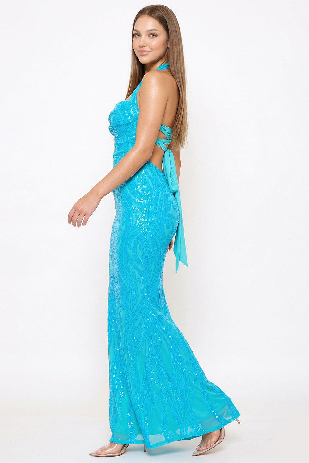 Boutinie turquoise sequin mermaid gown with a halter neckline and open lace-up back for formal evening events.