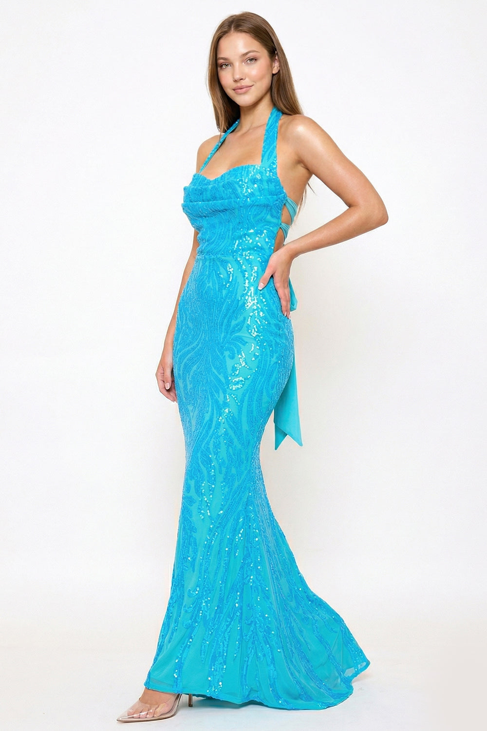 Bright blue sequin mermaid evening gown with a cowl neckline and open back from Boutinie.