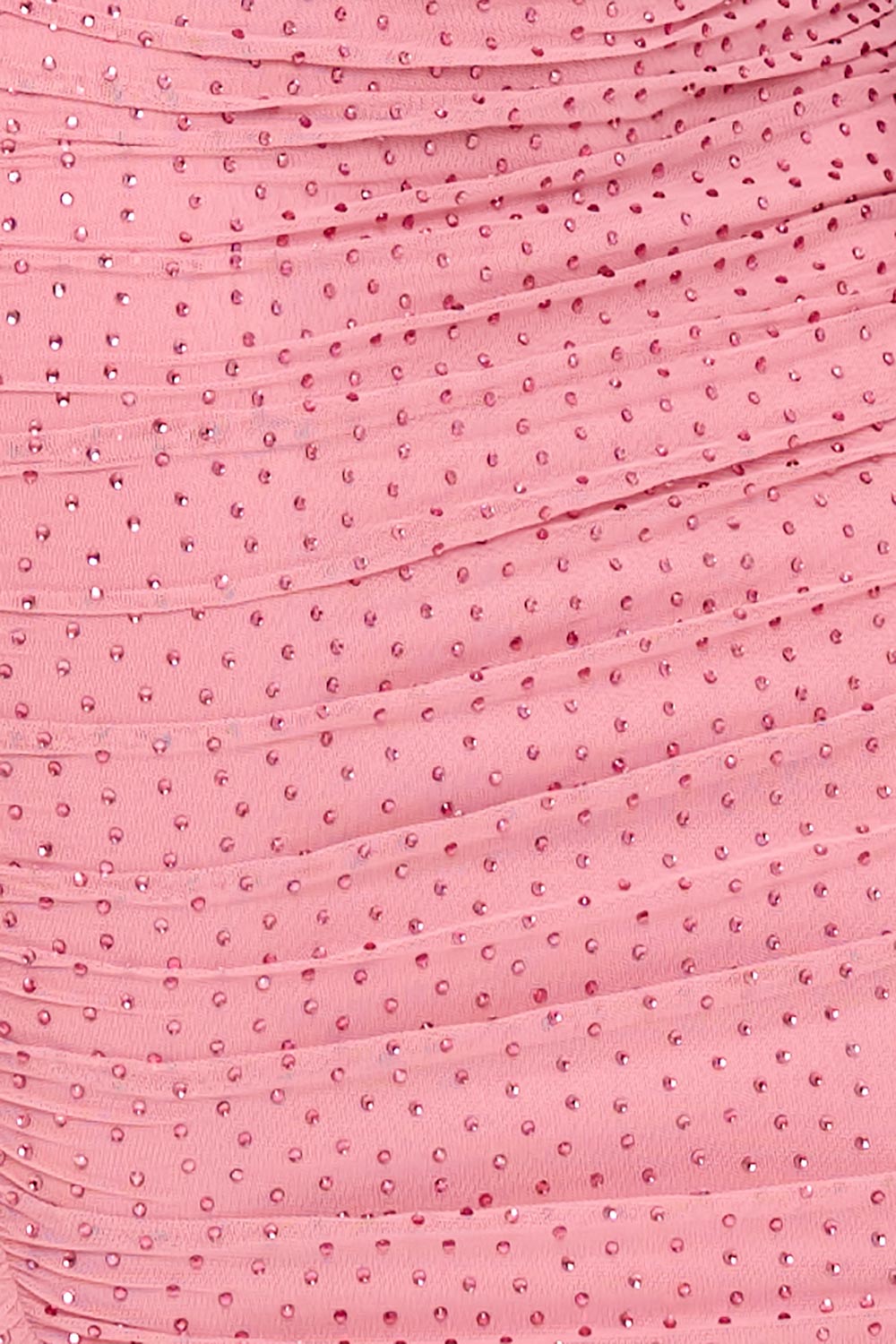 Close-up of a pink ruched mesh fabric embellished with sparkling rhinestones, perfect for a glamorous party dress.