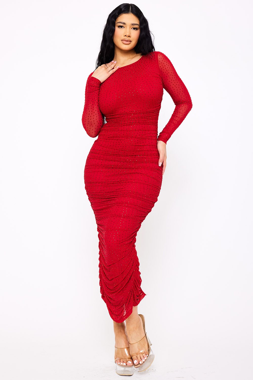 Model wearing a red long-sleeve ruched midi dress in sparkly dotted mesh, perfect for evening wear.