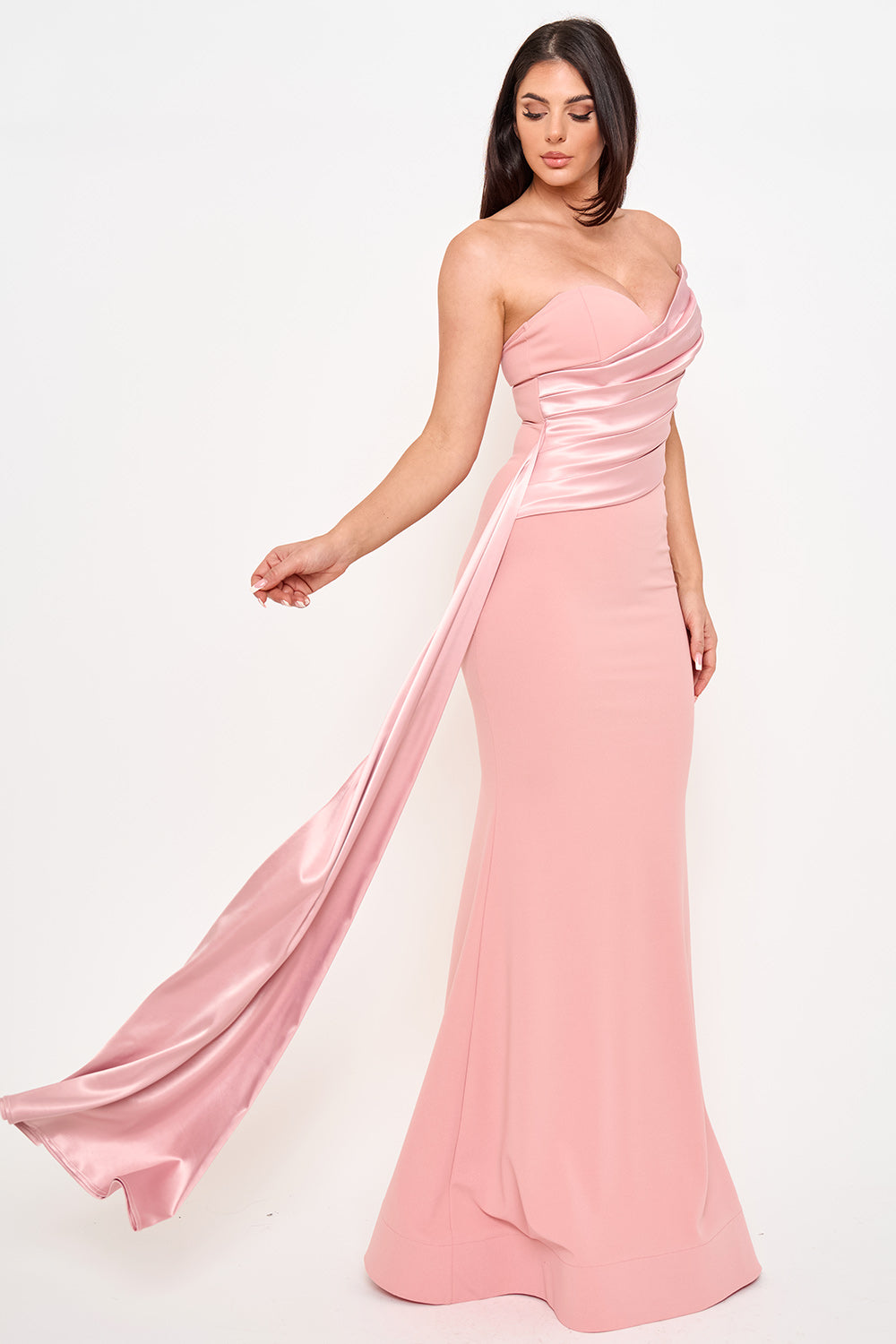 Boutinie blush pink strapless satin evening gown with a draped bodice and elegant floor-length mermaid silhouette.