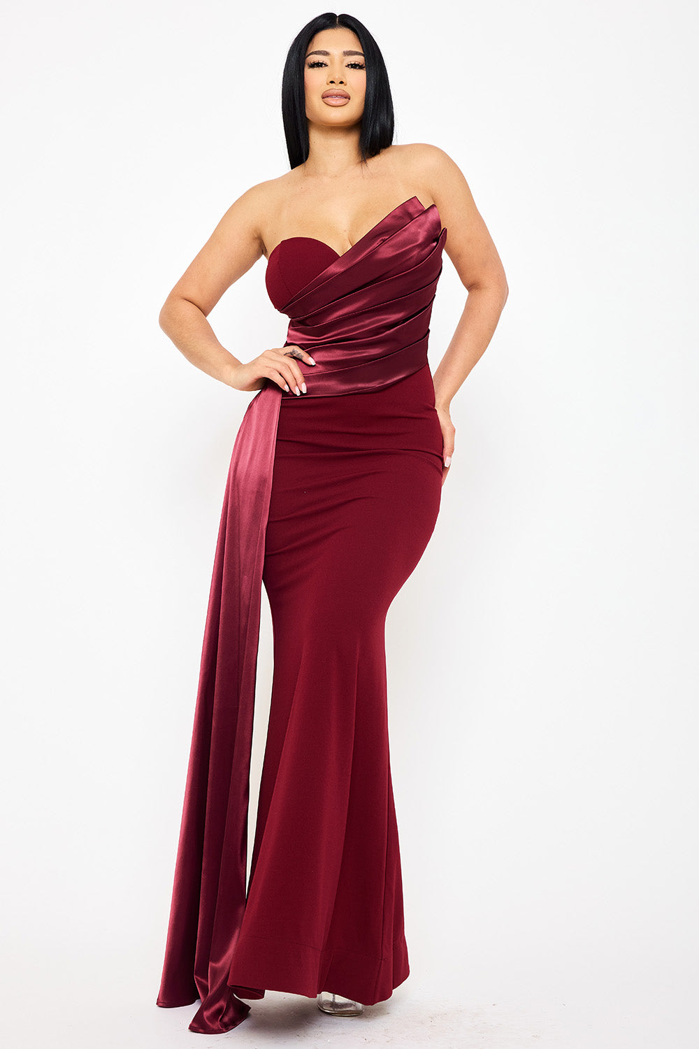 Burgundy strapless mermaid evening gown with draped satin bodice detail by Boutinie for formal occasions.