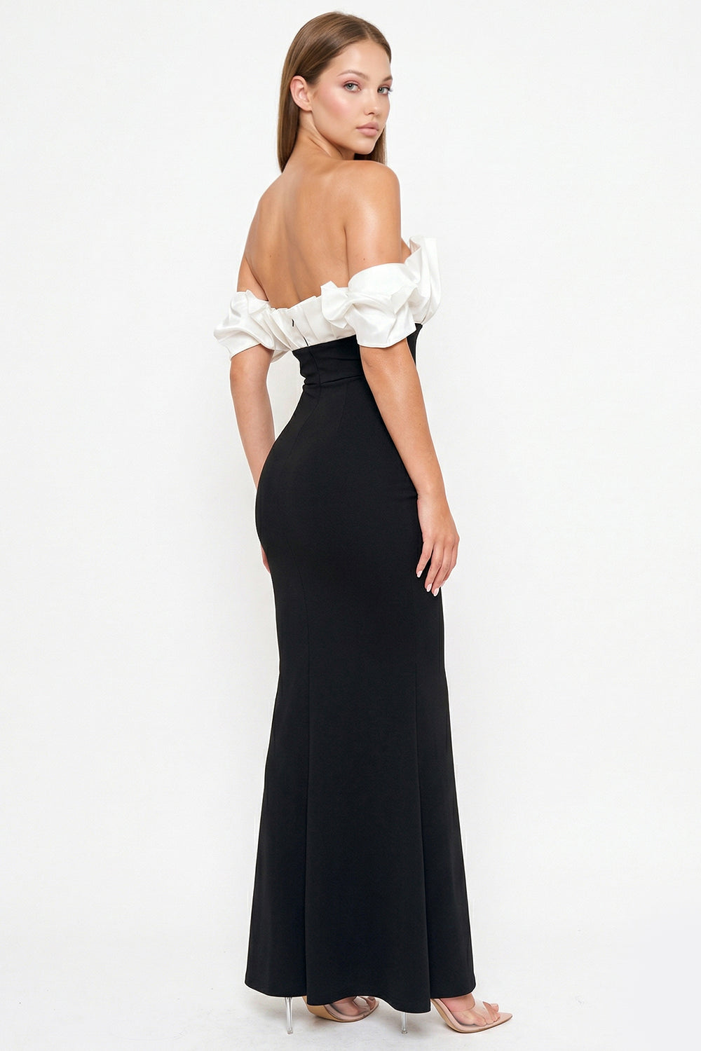 Boutinie black and white off-the-shoulder formal gown with ruffled sleeves and fitted mermaid silhouette.