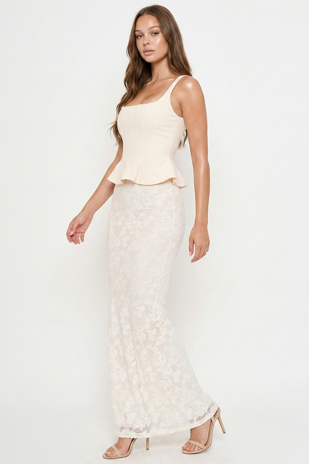 Cream corset-style peplum top with a sleeveless square neckline paired with a matching floor-length lace maxi skirt.