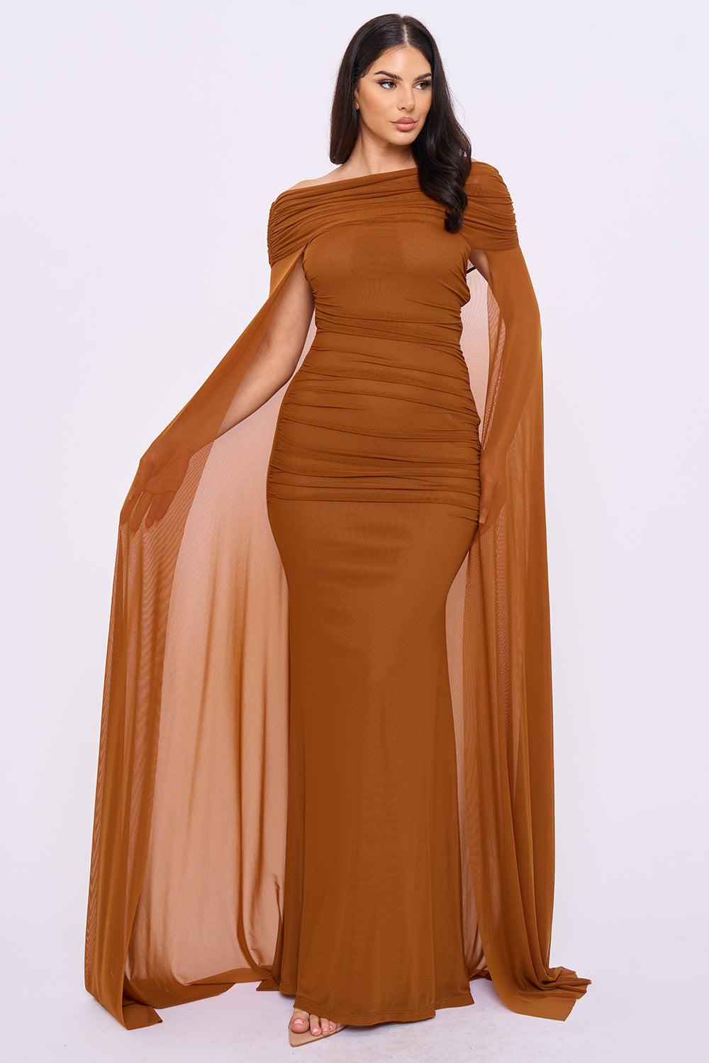 Brown ruched off-shoulder maxi evening gown with elegant mesh cape sleeves from Boutinie.