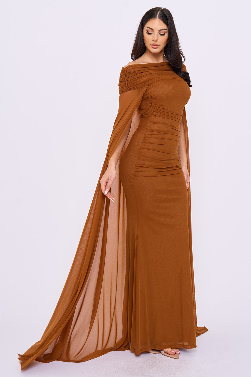 Brown ruched maxi dress with off-shoulder neckline and elegant sheer cape sleeves for formal occasions at Boutinie.