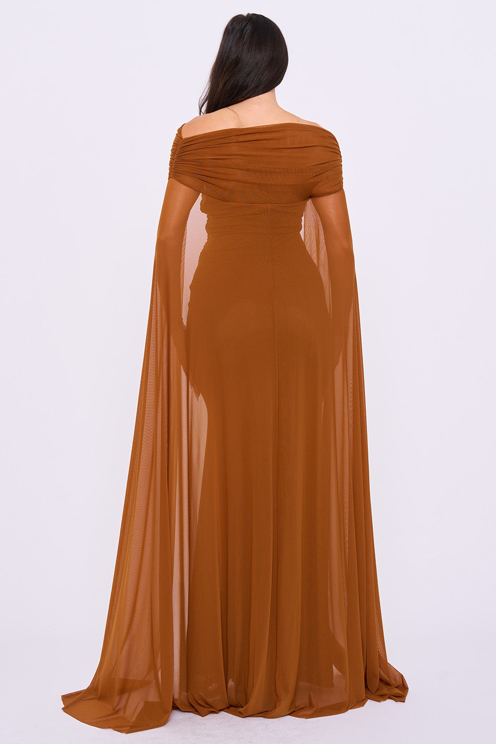 Rust-colored off-shoulder mesh evening gown with dramatic cape sleeves and a floor-length silhouette by Boutinie.