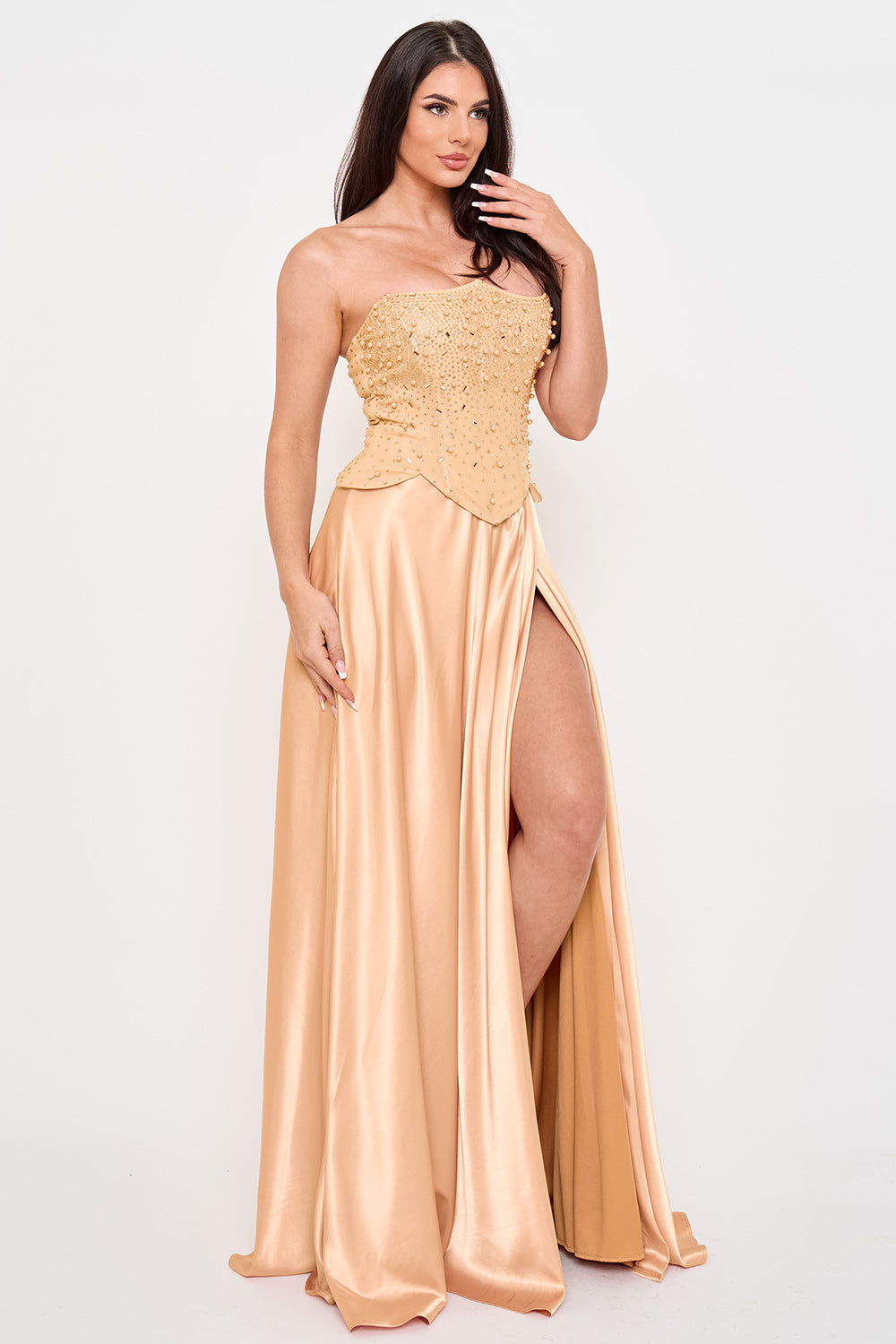 Champagne satin formal gown with a beaded strapless corset bodice and a high-slit floor-length skirt by Boutinie.