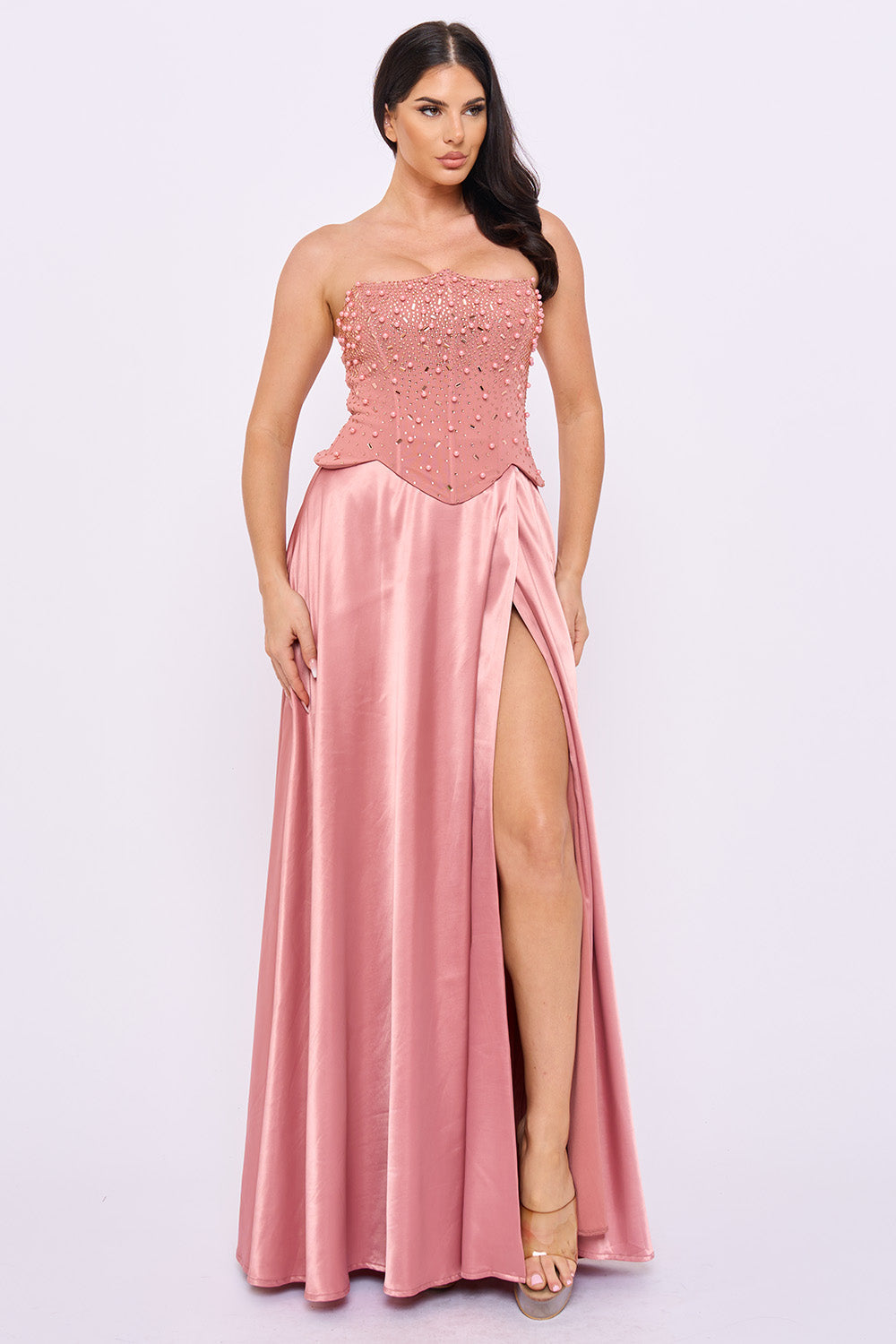 Pink strapless formal gown with pearl-beaded corset bodice and a high-slit satin floor-length skirt by Boutinie.