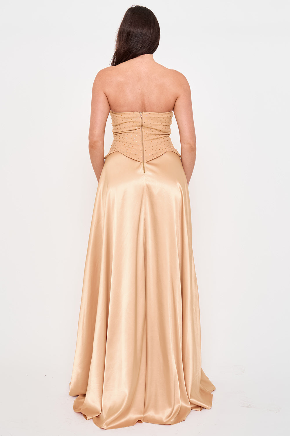 Back view of a strapless beige satin formal gown with a rhinestone-embellished corset bodice from Boutinie.
