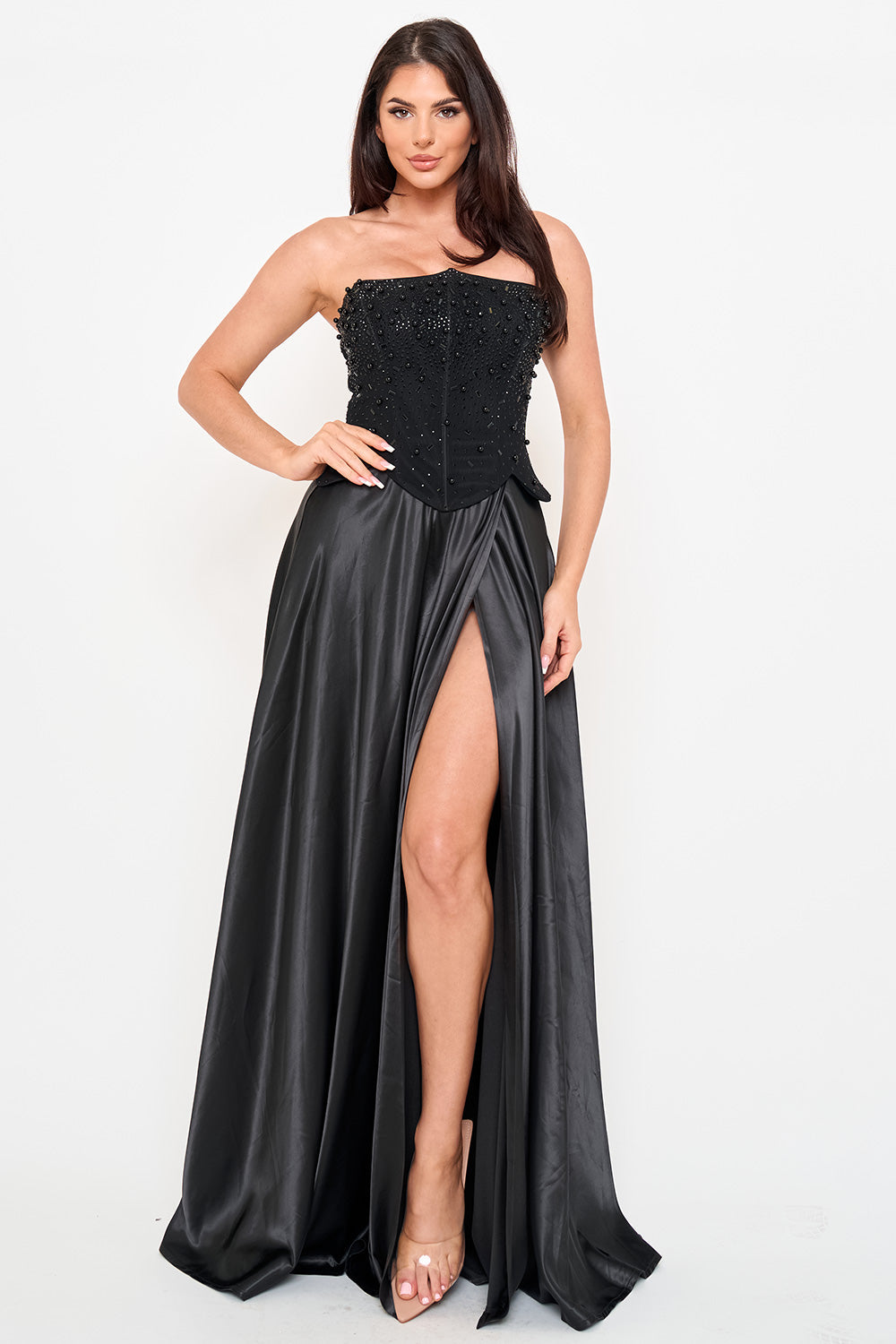 Black strapless corset evening gown with pearl embellishments and a high-slit satin skirt from Boutinie.