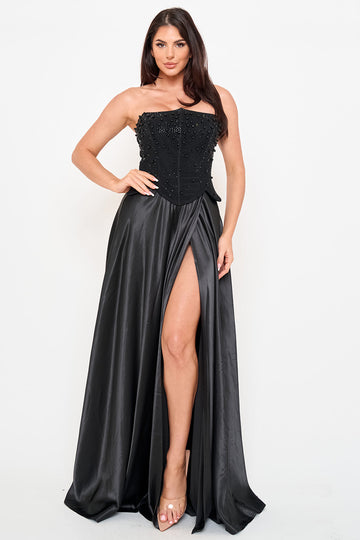 Black strapless corset evening gown with pearl embellishments and a high-slit satin skirt from Boutinie.