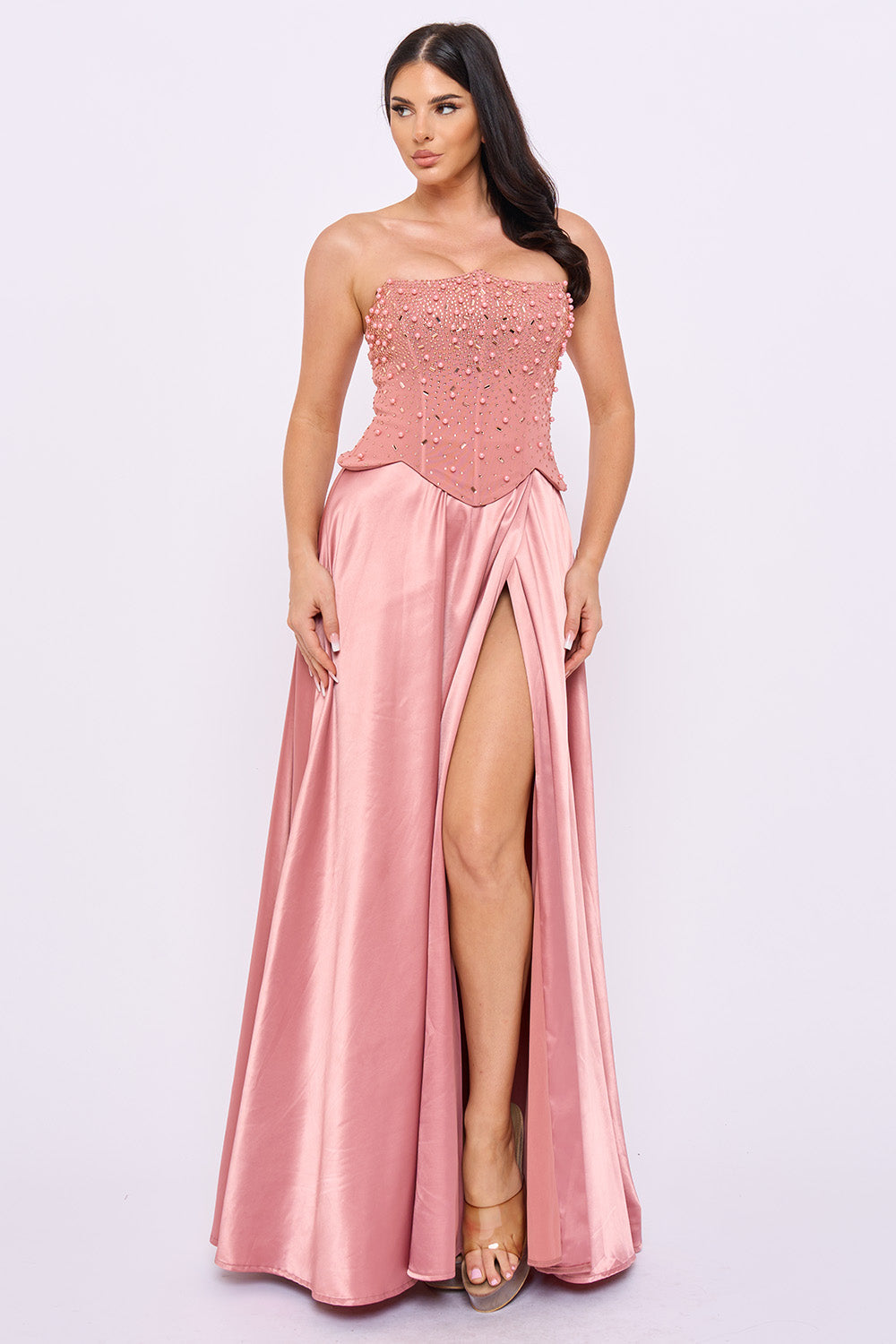 Dusty rose strapless formal gown with a beaded corset bodice and high-slit satin skirt from Boutinie.