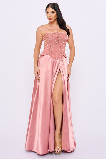 Dusty rose strapless formal gown with a beaded corset bodice and high-slit satin skirt from Boutinie.