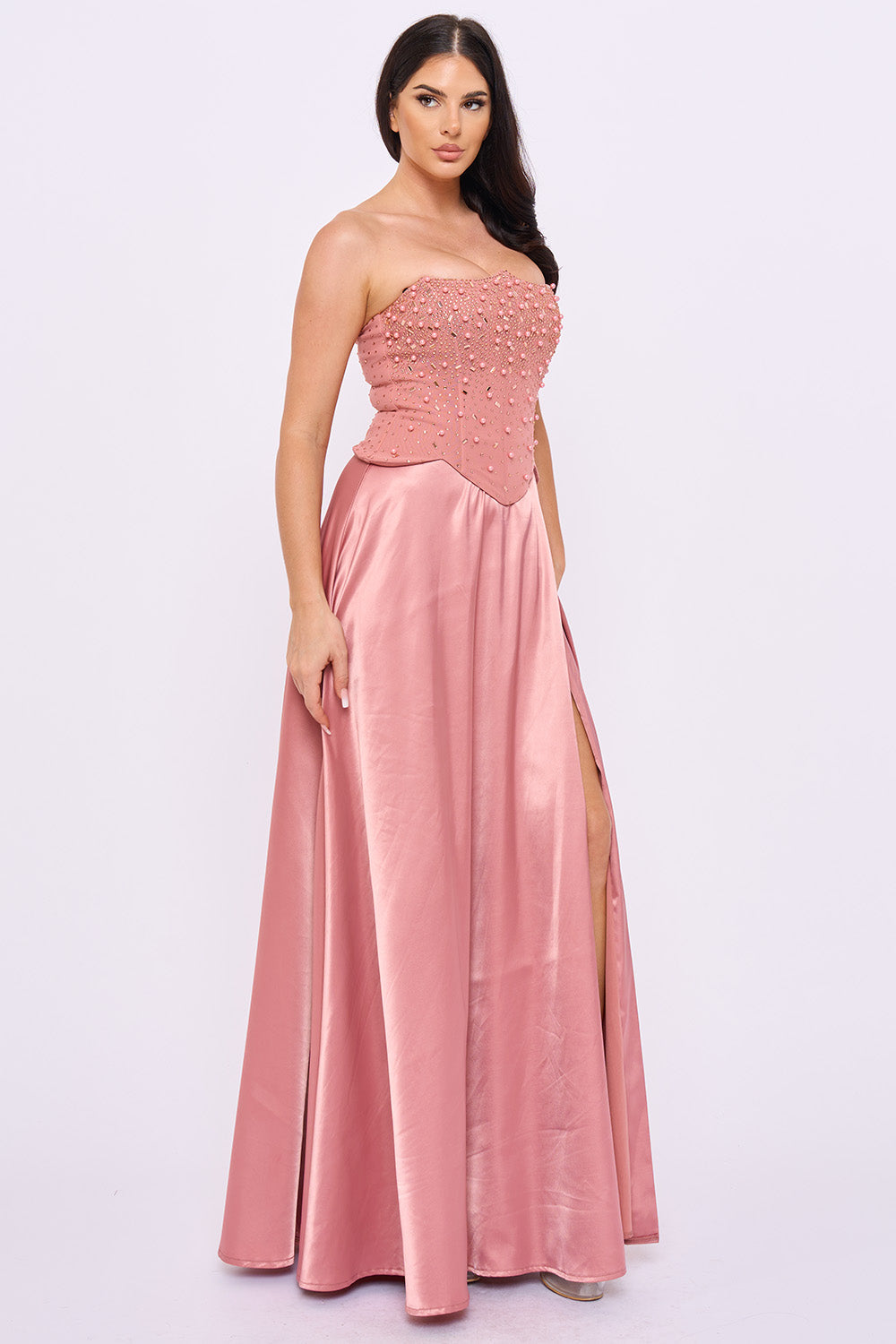 Pink strapless satin gown with a beaded bodice and high leg slit, perfect for formal events from Boutinie.