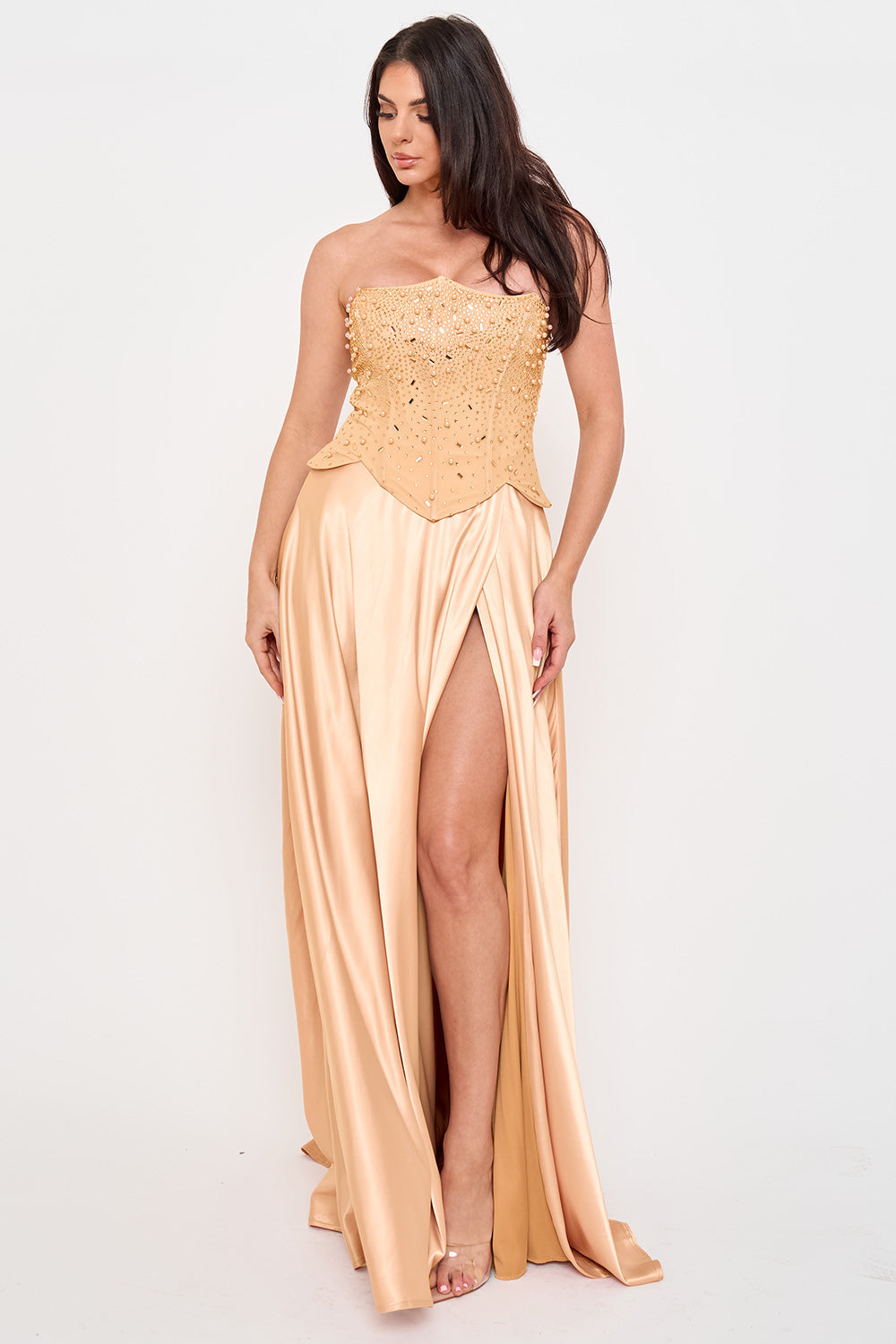 Champagne strapless corset gown with pearl embellishments and a high-slit satin skirt, perfect for formal events.