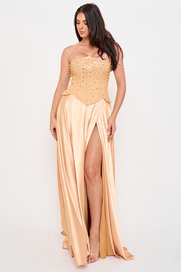Champagne strapless corset gown with pearl embellishments and a high-slit satin skirt, perfect for formal events.