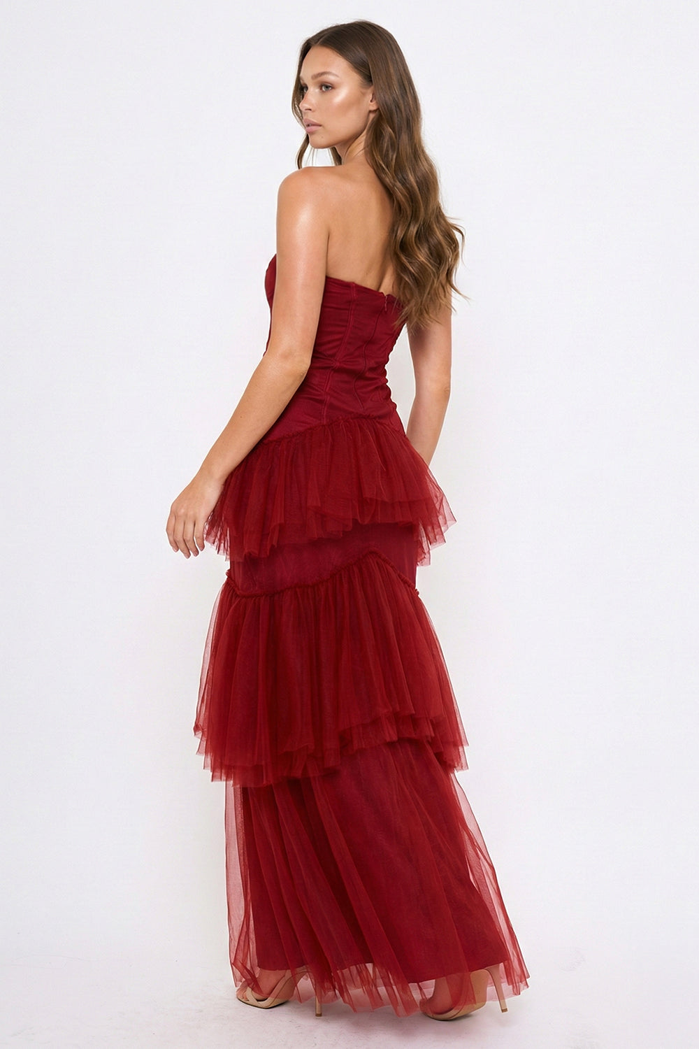 Burgundy strapless corset bodice tulle maxi dress with tiered ruffles for a formal event by Boutinie.