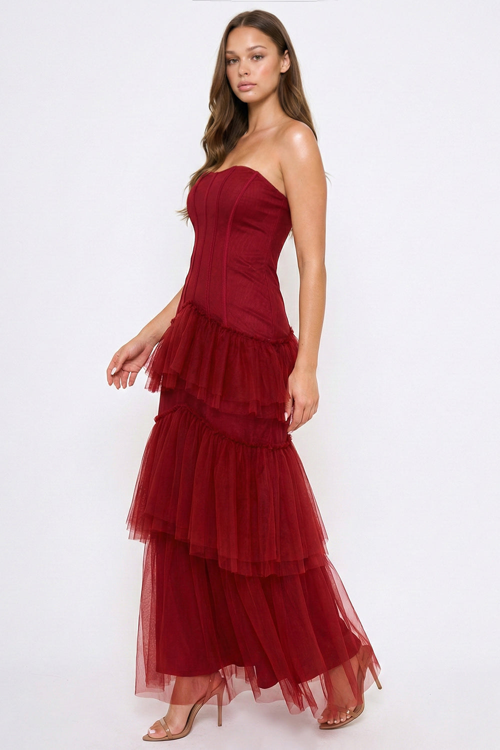 Boutinie burgundy strapless corset maxi dress with a tiered tulle skirt, perfect for formal evening occasions.