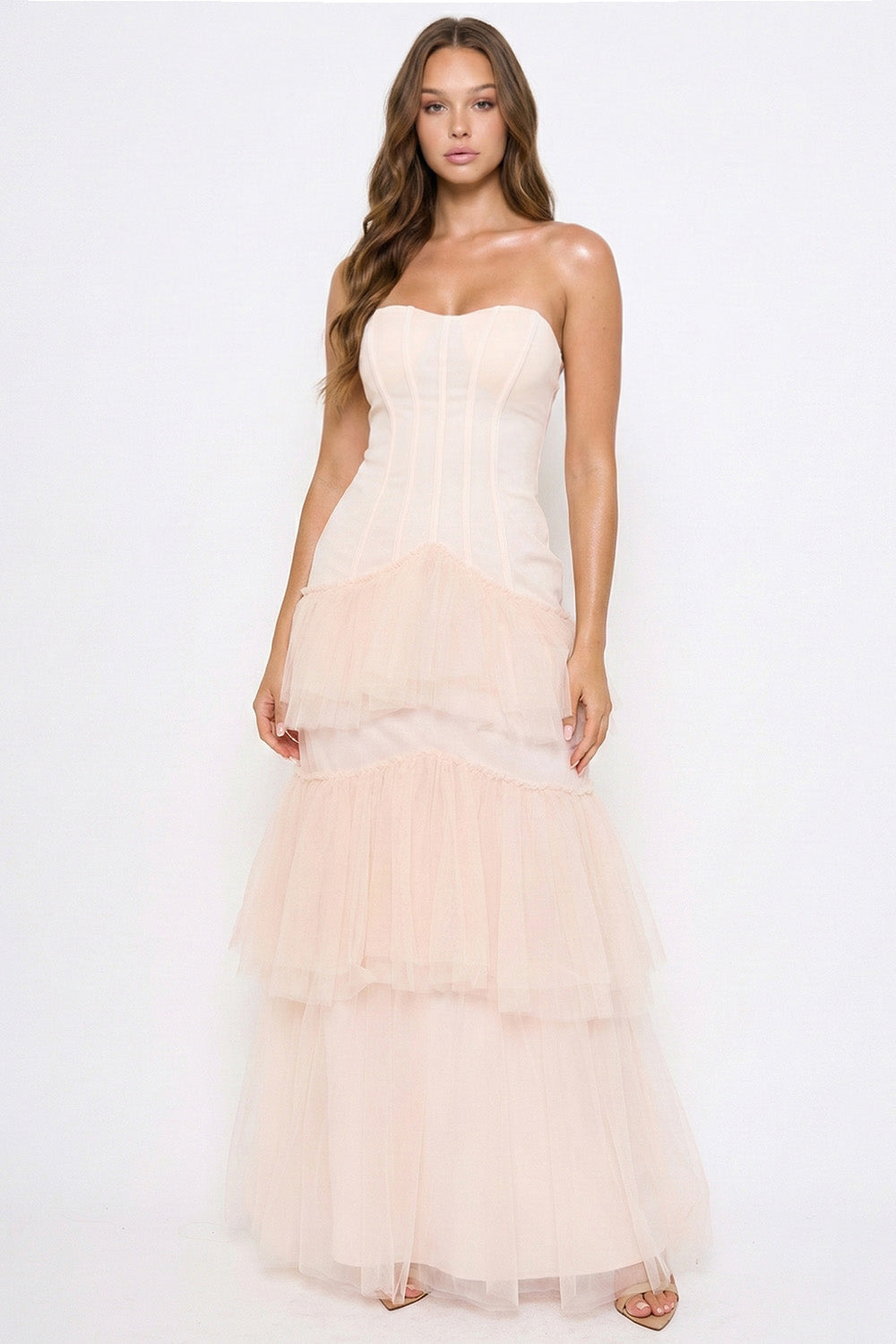 Strapless blush corset maxi dress with tiered tulle skirt, perfect for formal evening events by Boutinie.