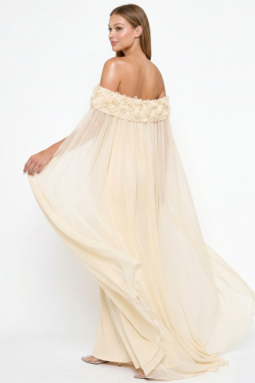 Cream off-the-shoulder chiffon gown with 3D floral neckline detail, perfect for elegant formal occasions at Boutinie.
