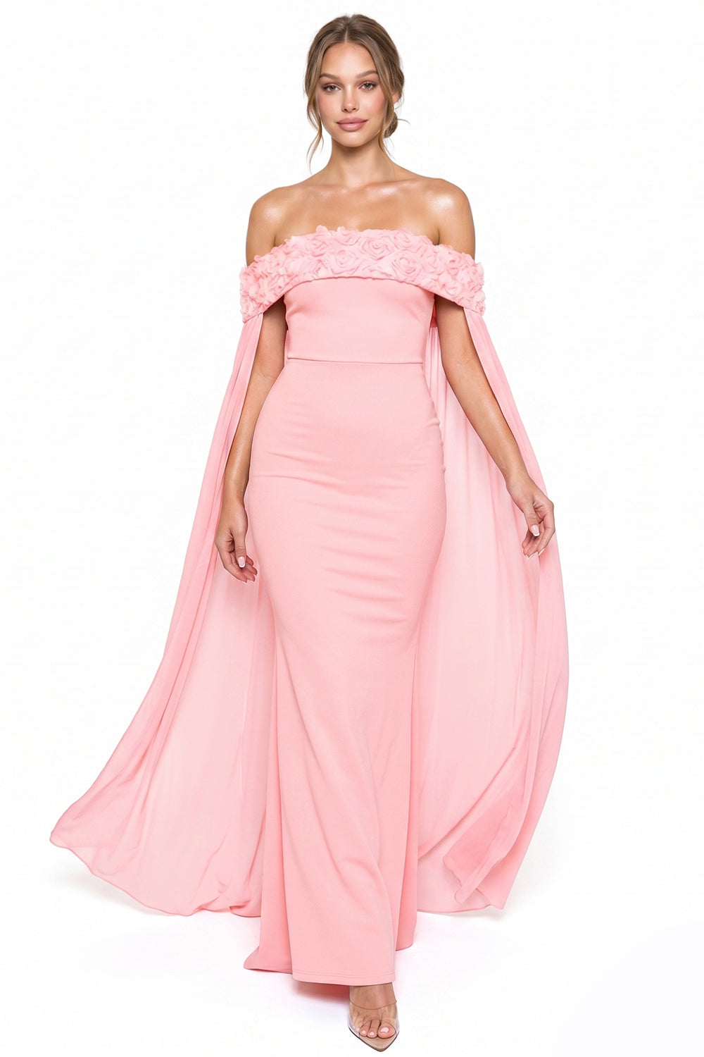 Pink off-shoulder evening gown with 3D floral neckline, flowing cape sleeves, and fitted silhouette from Boutinie.