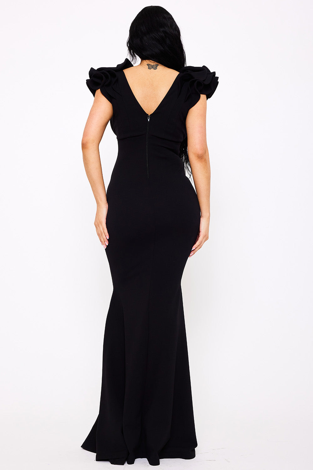 Back view of a black mermaid evening gown with a V-neckline and dramatic ruffled cap sleeves from Boutinie.