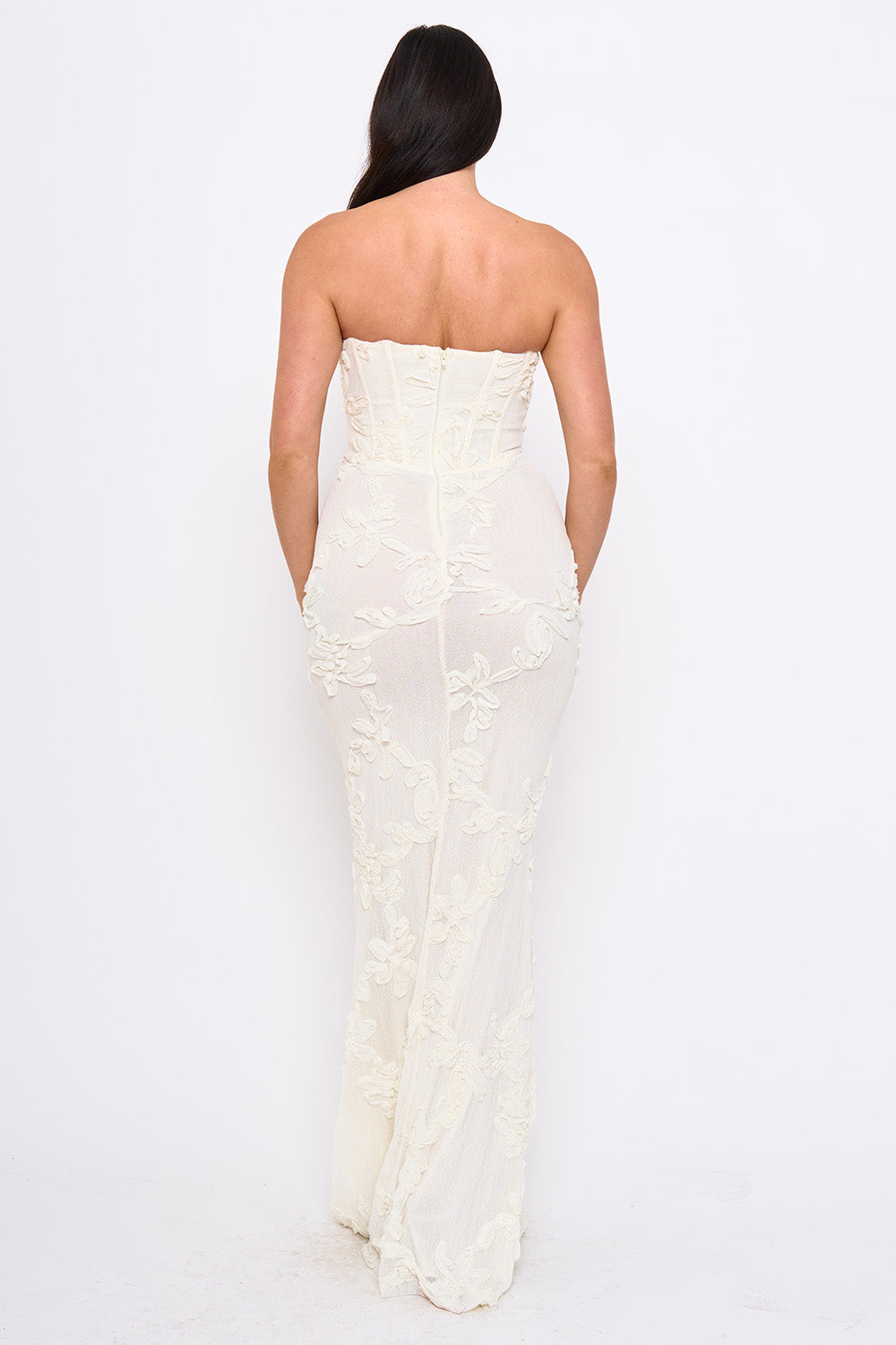 Back view of a white strapless floral lace corset maxi dress for formal occasions by Boutinie.