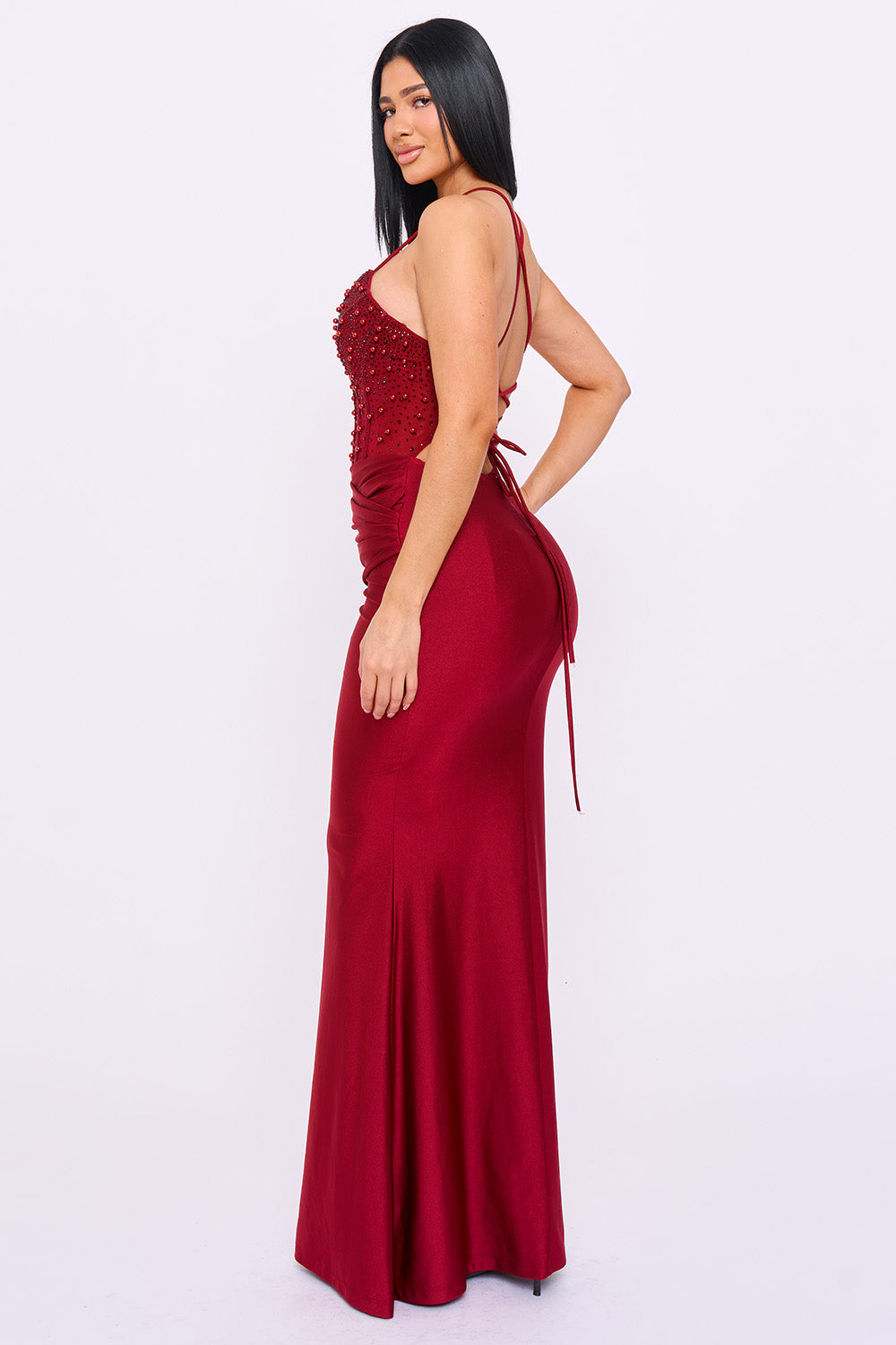 Boutinie burgundy satin formal gown featuring a beaded corset bodice, lace-up back, and sleek mermaid silhouette.