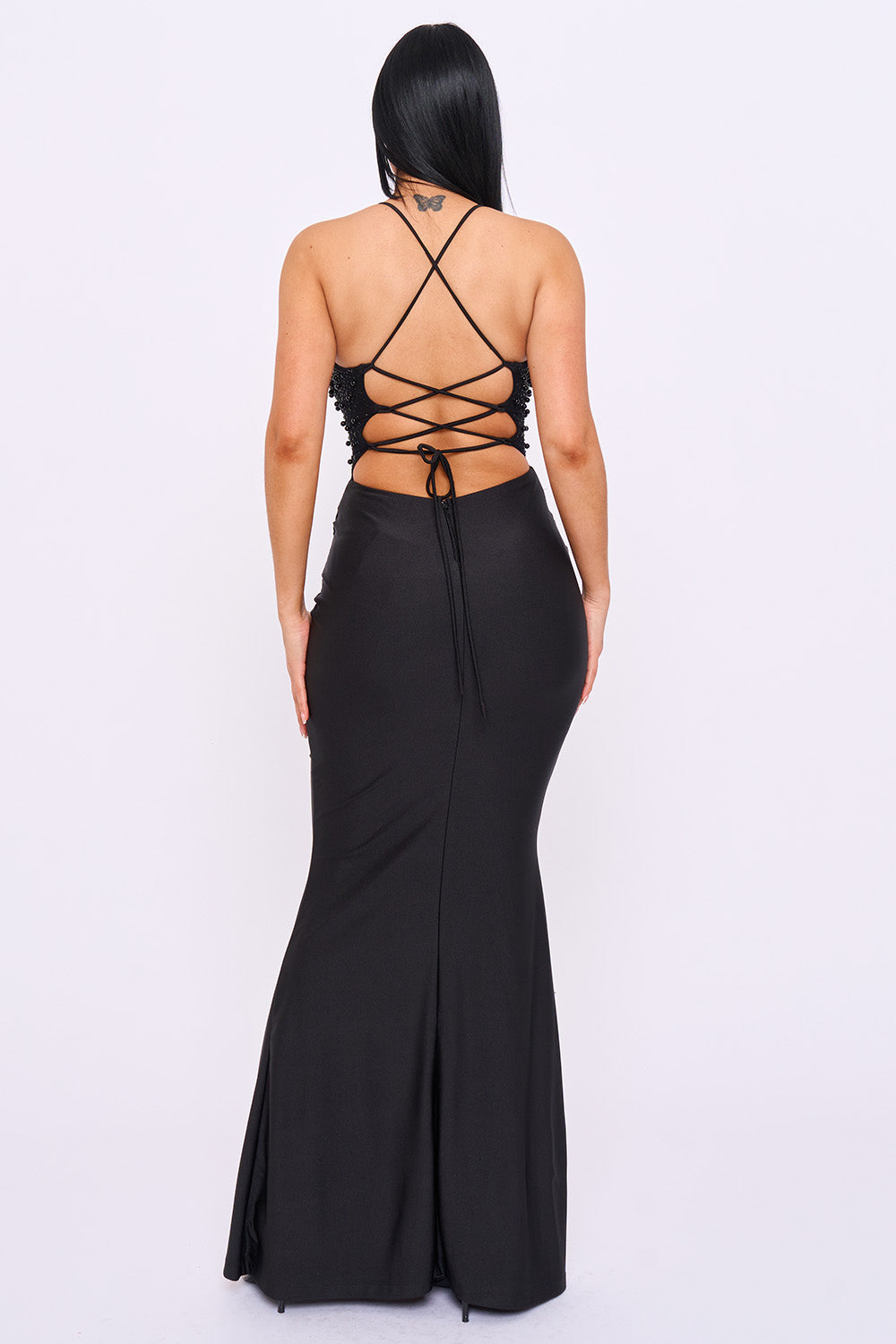 Black mermaid evening gown with a beaded bodice, lace-up back, and slim fit silhouette from Boutinie.
