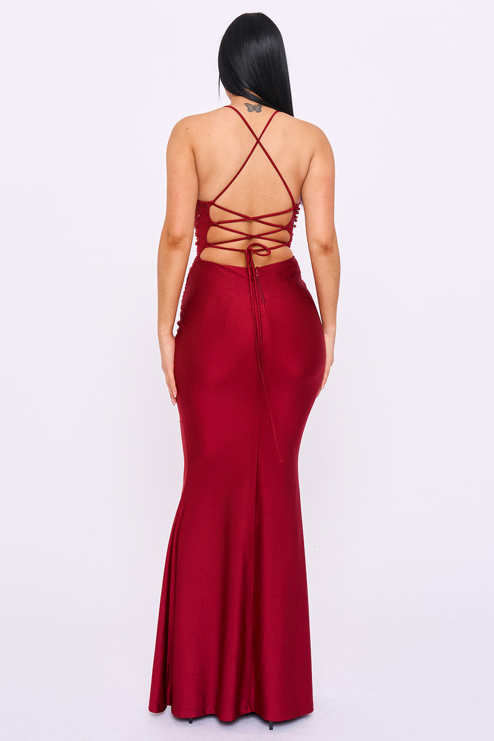 Boutinie red mermaid evening gown featuring a backless design with crisscross lace-up detailing and satin fabric.