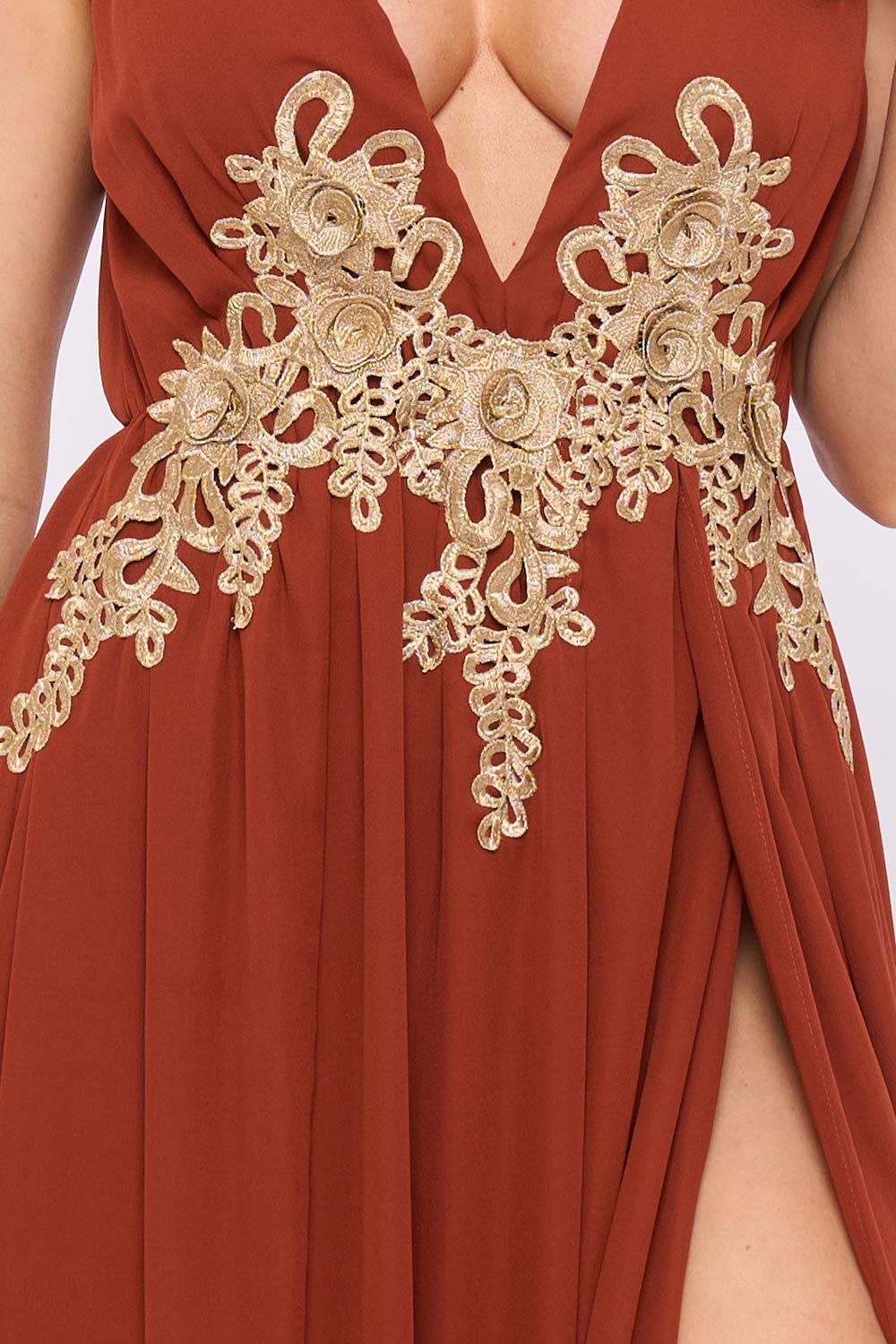 Rust orange formal maxi dress with gold floral embroidery, plunging neckline, and high-slit flowy fabric.