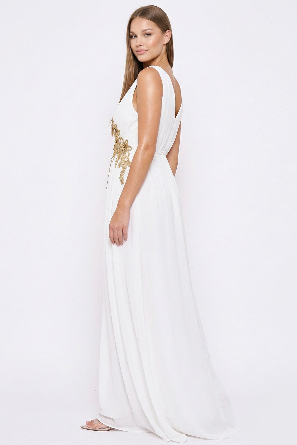 White sleeveless maxi dress with gold floral embroidery, V-neckline, and flowing skirt for special occasions.